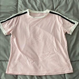 Pink t-shirt with black and white strips.